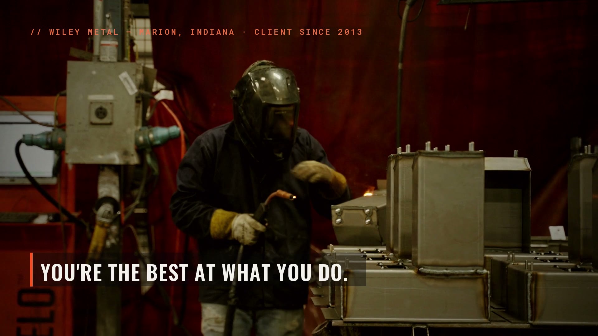 A welder throwing sparks on the Wiley Metal shop floor — still from the 21 Handshake brand film